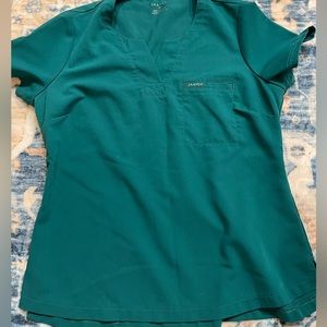 Hunter green jaanuu scrub top in size medium.